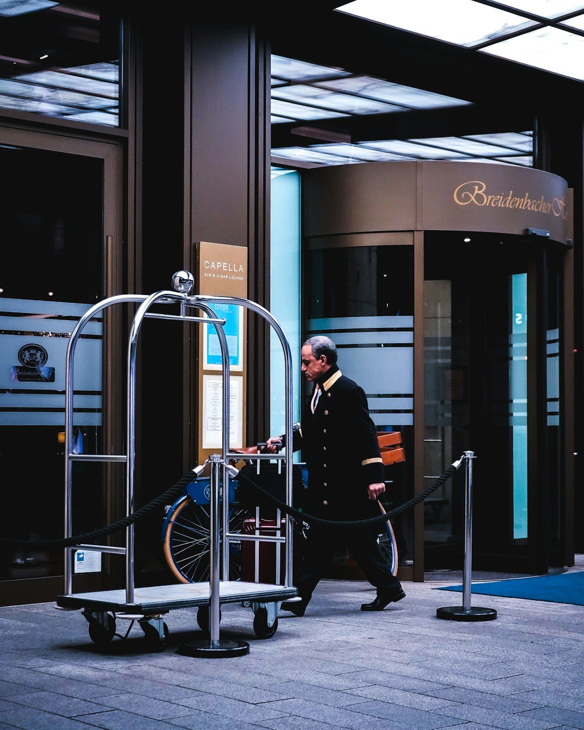 A hotel porter attending to luggage outside a hotel